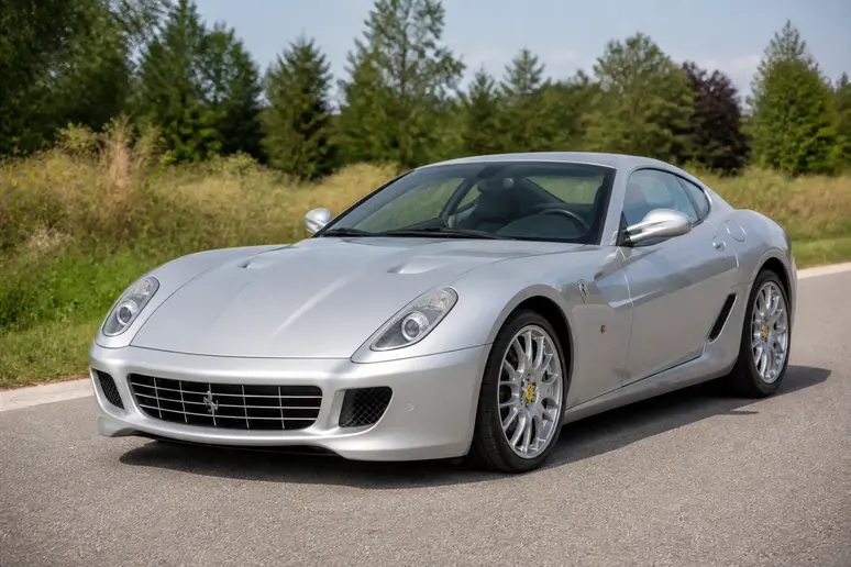 Coupé gris de sport stationné sur une route asphaltée montrant ses dimensions et son profil