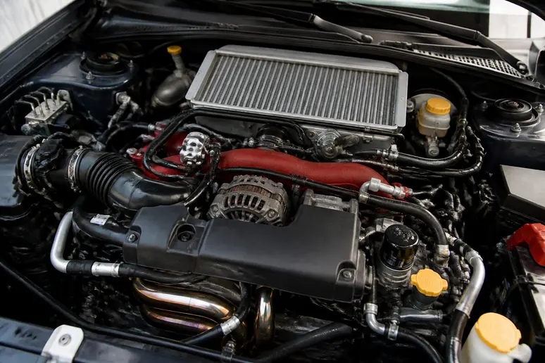 Vue rapprochée du moteur EJ25 turbo et de son échangeur air-air dans le compartiment moteur d'une Subaru Impreza WRX STI